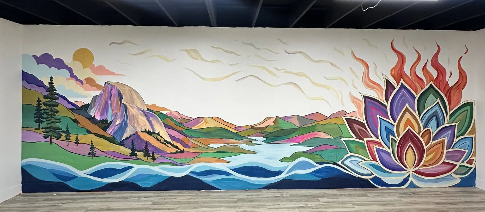 The Valley Lotus mural: Half Dome, a river and a lotus in flames across one long wall