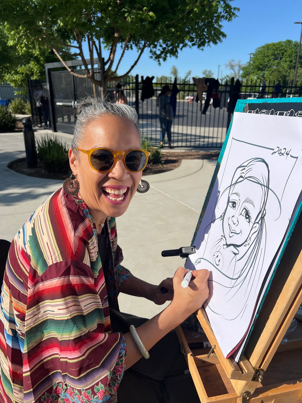 Susan Gromala drawing a live caricature portrait outdoors